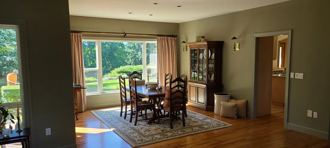 Repainted dining room with large windows and hardwood floors
